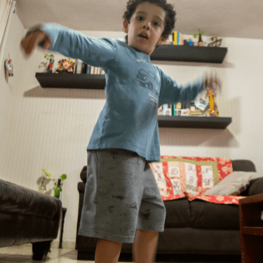 Child dancing while watching fun French class