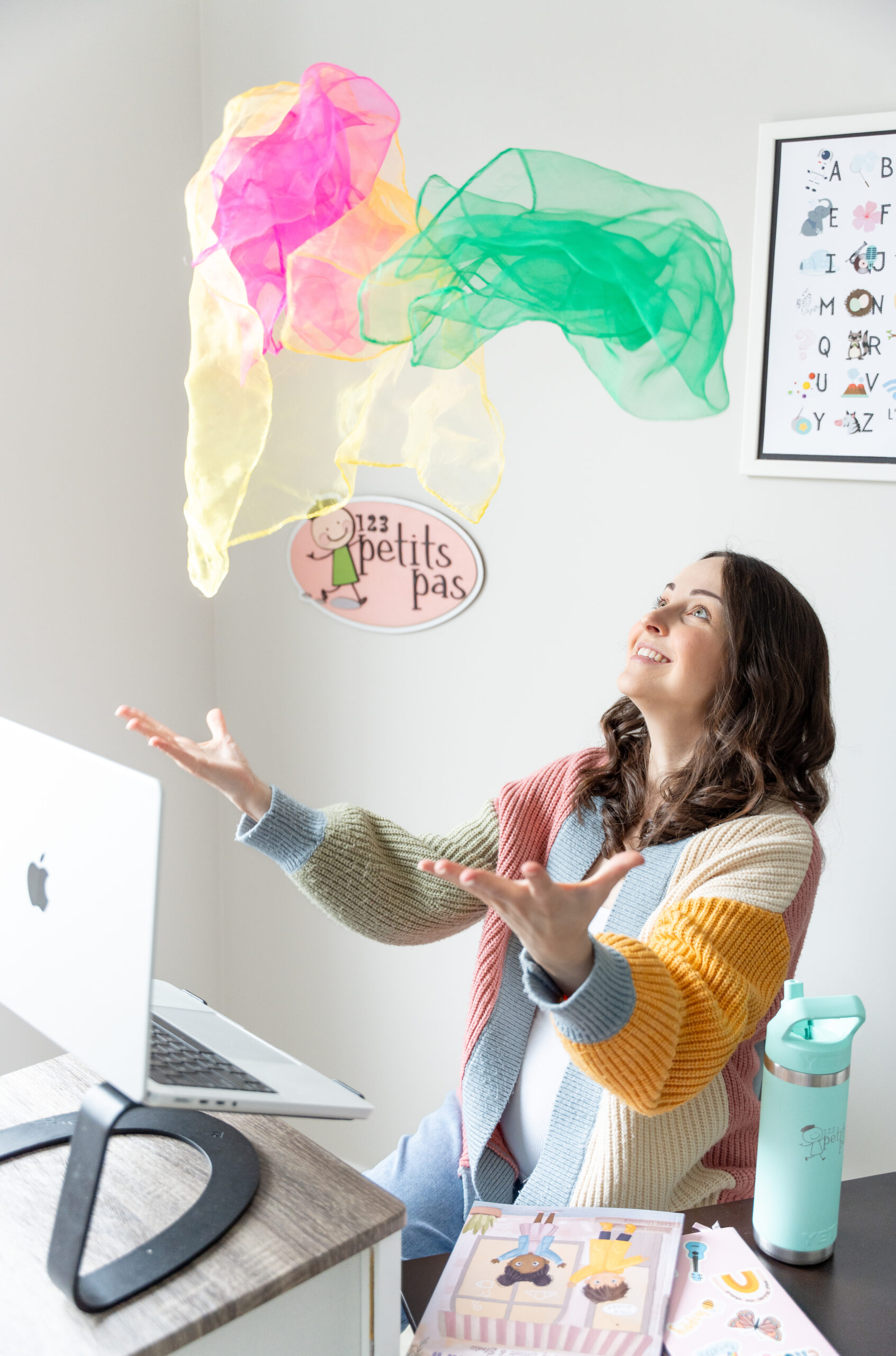 Madame Amy teaching with a colourful spring toy and classroom puppet